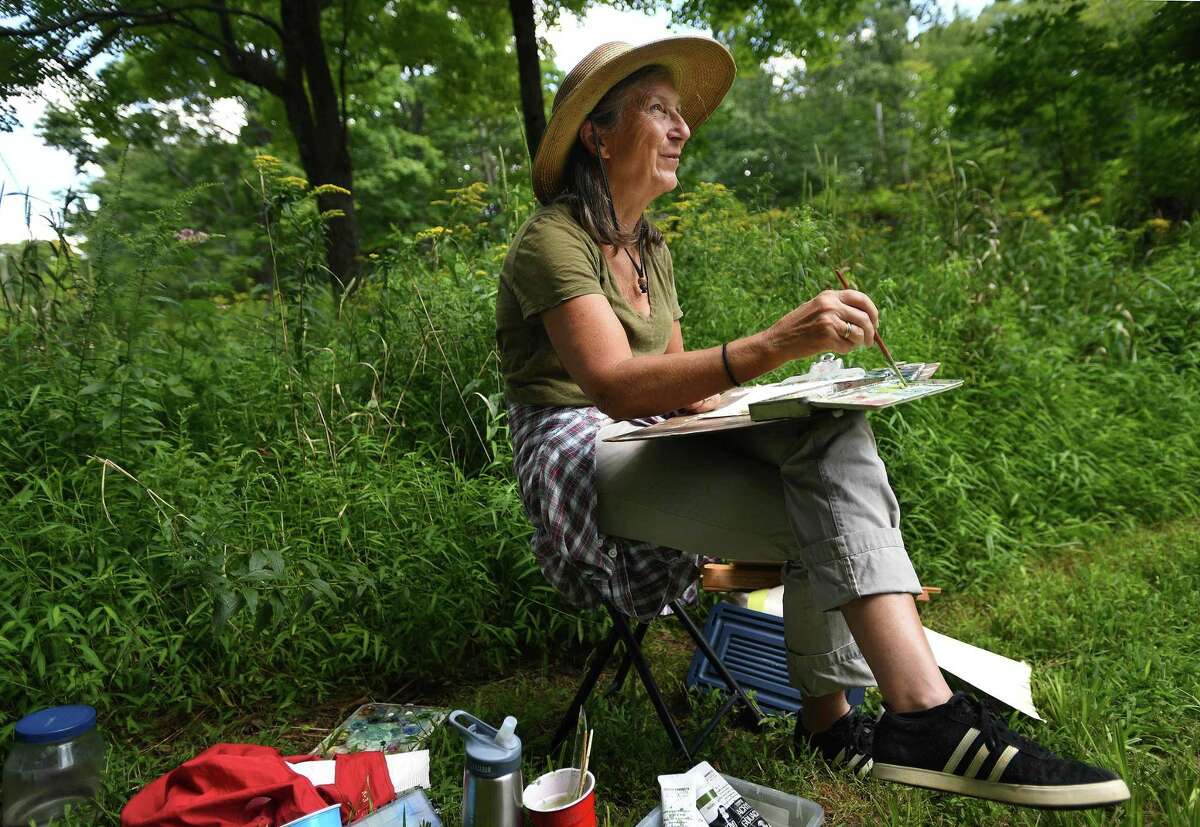 Francesca Monro, of Wilton, paints in a wildflower meadow during the Art in the Park Annual Festival at Weir Farm National Historic Site on Sunday. The site was the summer residence of American impressionist painter J. Alden Weir.