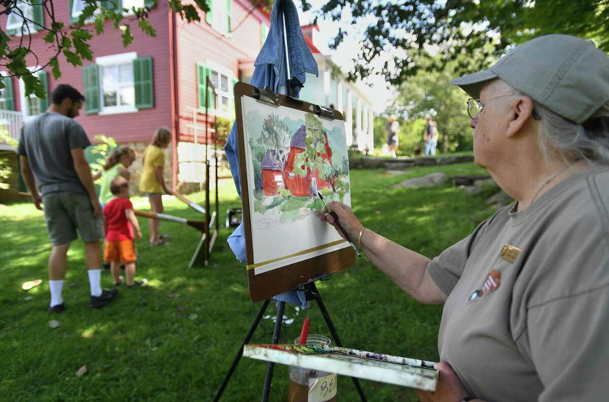 Artist Bobbi Eike Mullen, of Georgetown, paints during the Art in the Park Annual Festival at Weir Farm National Historic Site, in Wilton and Ridgefield, on in August 2019. The site was the summer residence of American Impressionist painter J. Alden Weir.