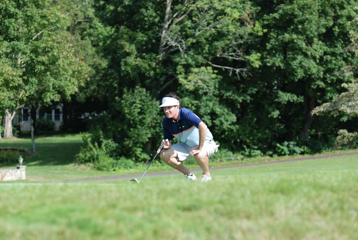 Ridgefield High grad Rick Hayes lines up a shot during the first round of the state's Mid-Amateur championship Monday. Hayes shared the lead with another player.