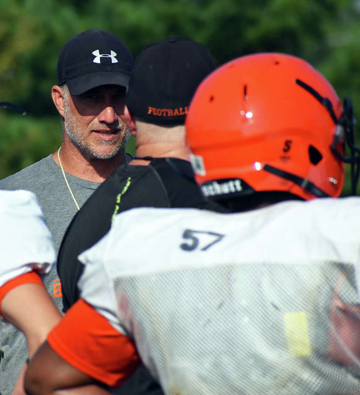 EHS football coach Matt Martin, back, talks to an assistant coach during a summer workout.