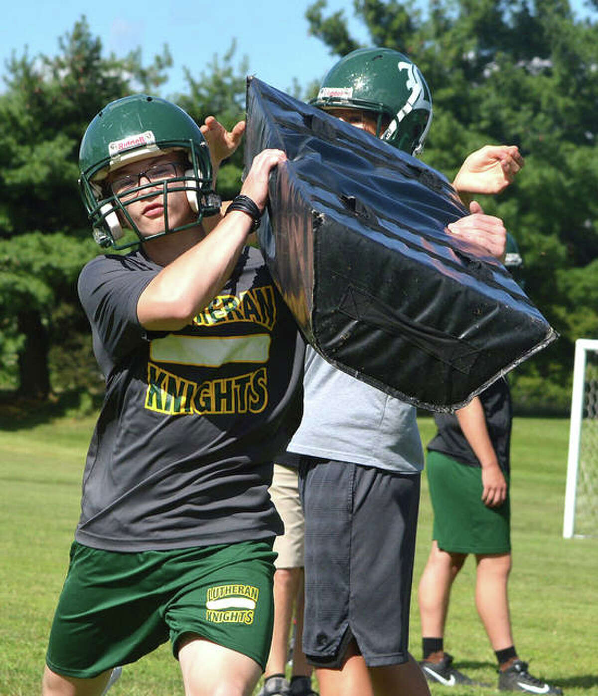The Metro-East Lutheran Knights run through drills on the first day of practice.