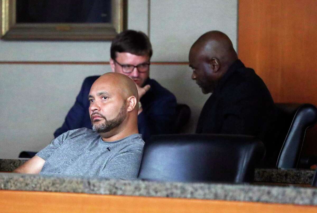 Former Houston police officers Steven Bryant, foreground, and Gerald Goines, background, turn themselves in at the Civil Courthouse, Friday, August 23, 2019, in Houston. Goines, a former Houston police officer has been charged with murder in connection with the deadly January drug raid of a home that killed a couple who lived there and injured five officers, prosecutors announced Friday.