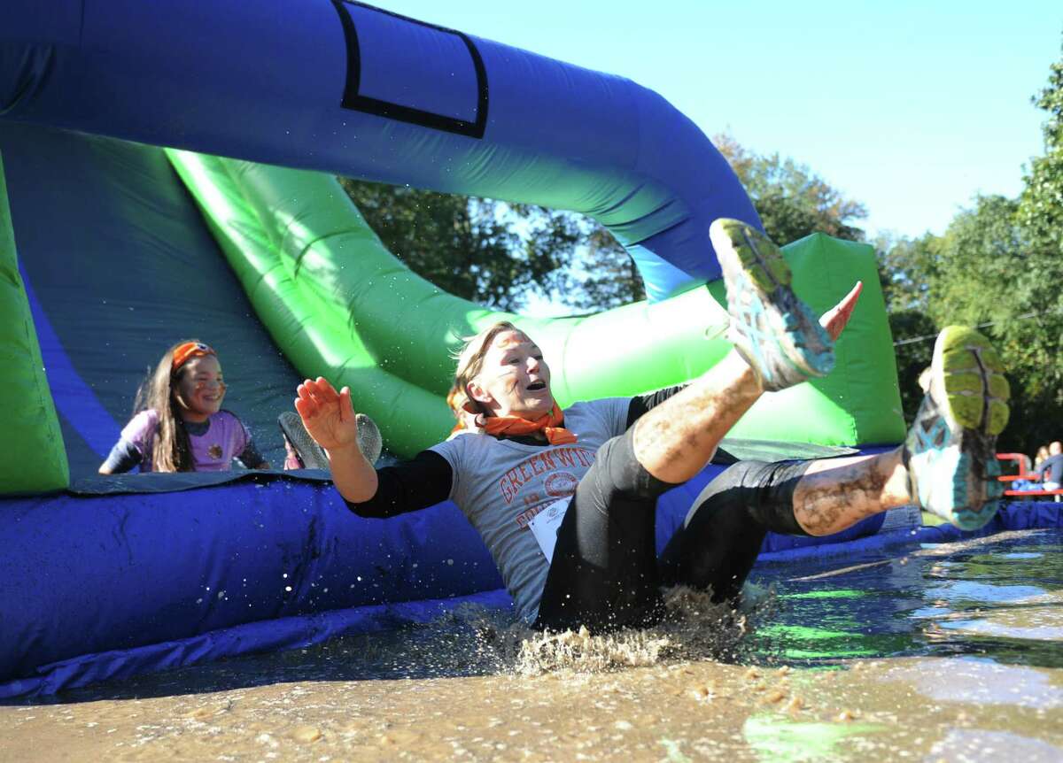 Photos from the Muddy Up 5K Run and Family Walk at Camp Simmons in Greenwich, Conn. Sunday, Oct. 1, 2017. Hundreds of participants ran through the course full of man-made obstacles including several mud pits. Proceeds from the event benefited the Boys & Girls Club of Greenwich.