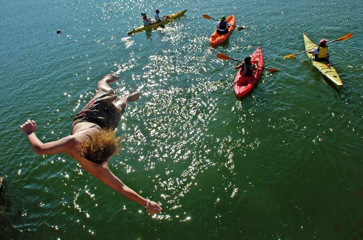 Downunder kayakers pass under the Bell Island bridge in 2007 in Norwalk, Conn. The paddle center is shutting down three Fairfield County locations after Labor Day weekend in 2019. Andrew Sullivan/Staff photo