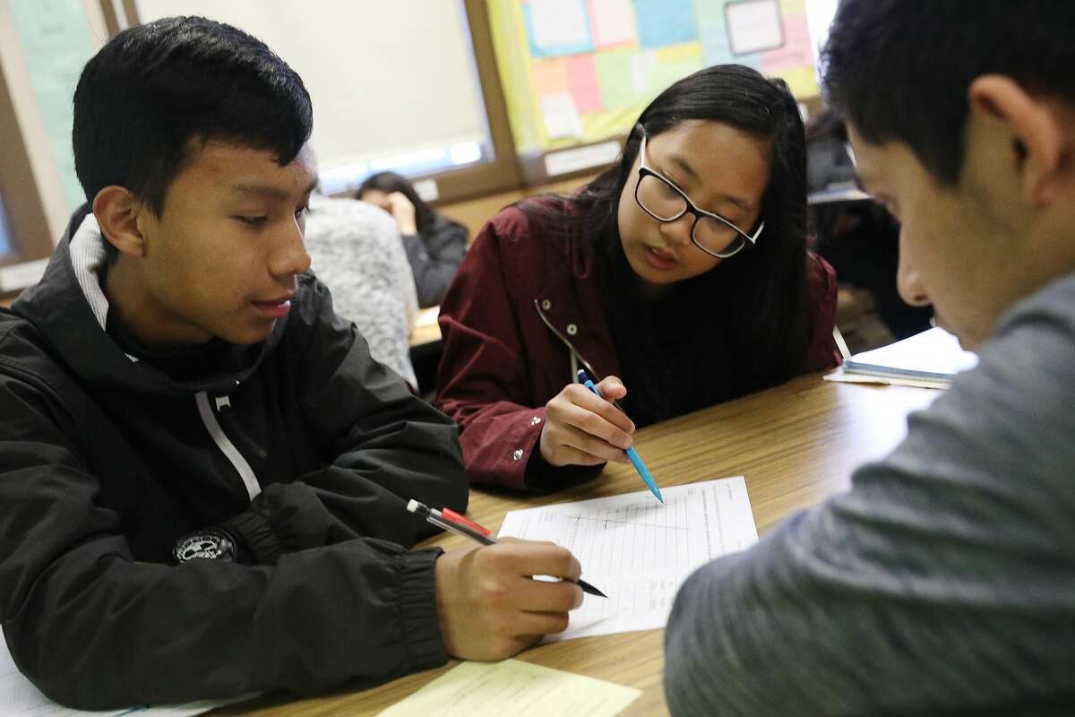 Mission High School juniors Johnny Mejia (l to r), Aila Alli and Anthony Garcia work in a group on a class assignment on inverse functions during Dayna Soares' Algebra II class at Mission High School on Tuesday, January 8, 2019 in San Francisco, Calif.