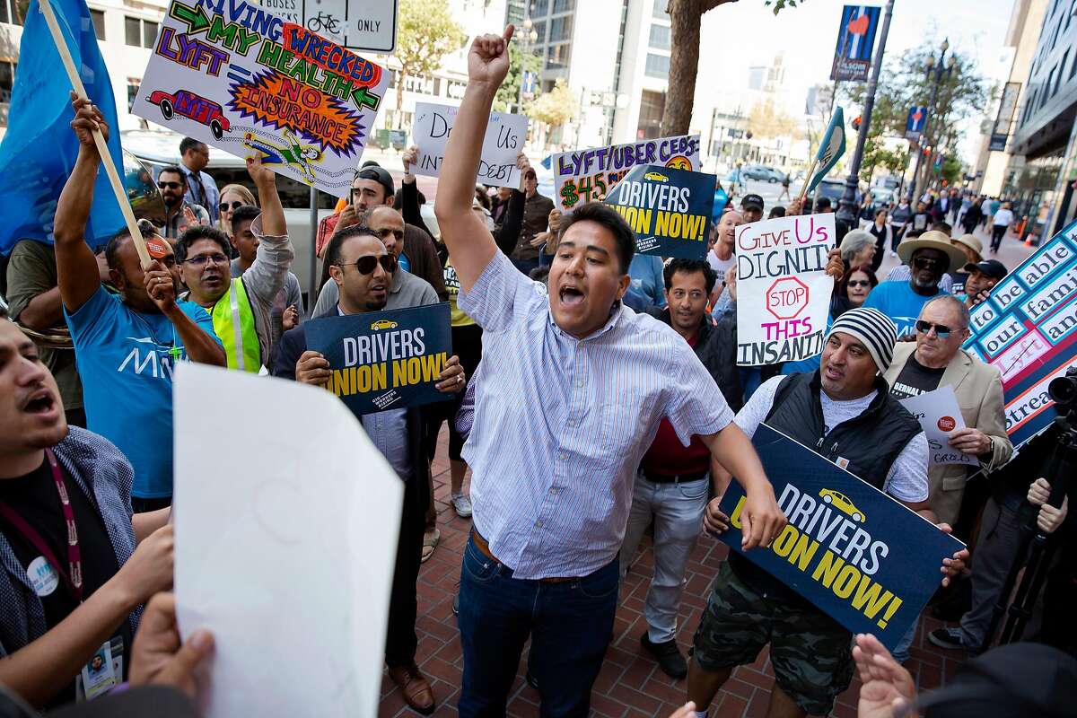 Felipe Caceres, an organizer with Mobile Workers Alliance, leads a chant during a protest outside of Uber's Headquarters on Market Street in San Francisco, Calif. on Tuesday, August 27, 2019. Tuesday's protest is part of a three-day drive from Los Angeles to Sacramento to advocate for bill AB5 that would classify gig workers as employees.