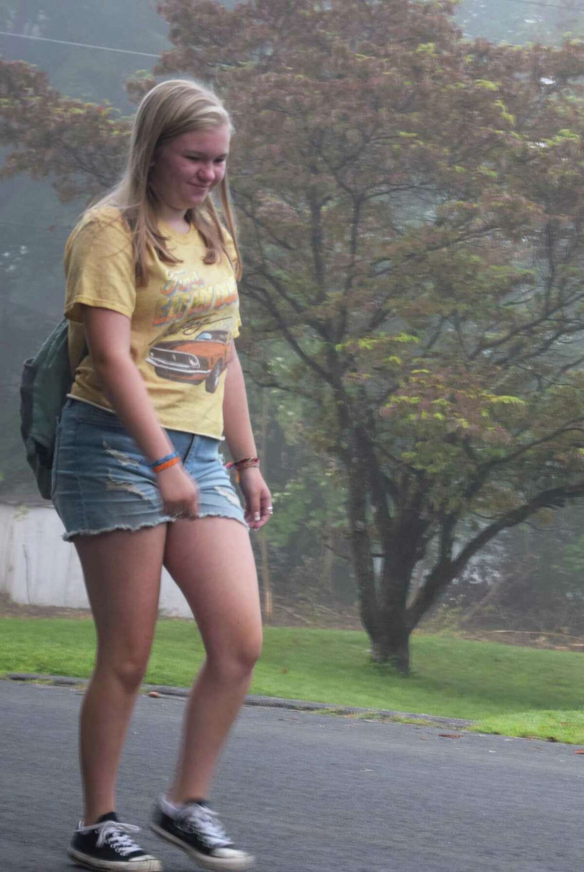 Marissa Gillette makes her way through the early morning fog on her way to the bus stop for her first day of school as a freshman at New Milford High School.