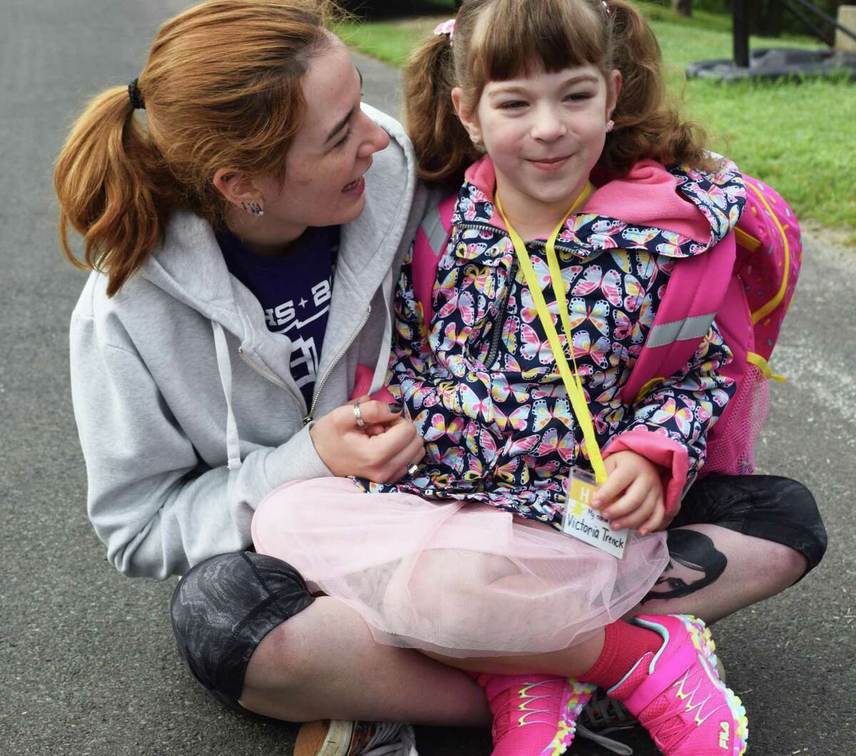 Spectrum/New Milford students headed back to school Tuesday, Aug. 27, 2019. Above, kindergartner Victoria Trenck finds her aunt Kristina Trenck's lap a perfect spot to wait for her bus.