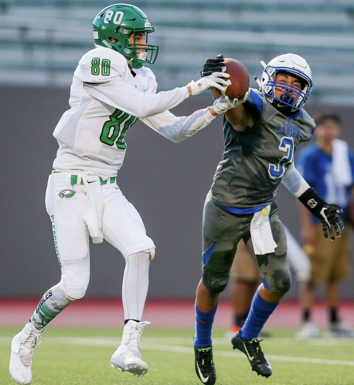 Lanier's Savian Perez (right) defends a pass intended for Pleasanton's Dalton Hobbs during the first half of their high school football game at Alamo Stadium on Thursday, Sept. 6, 2018.