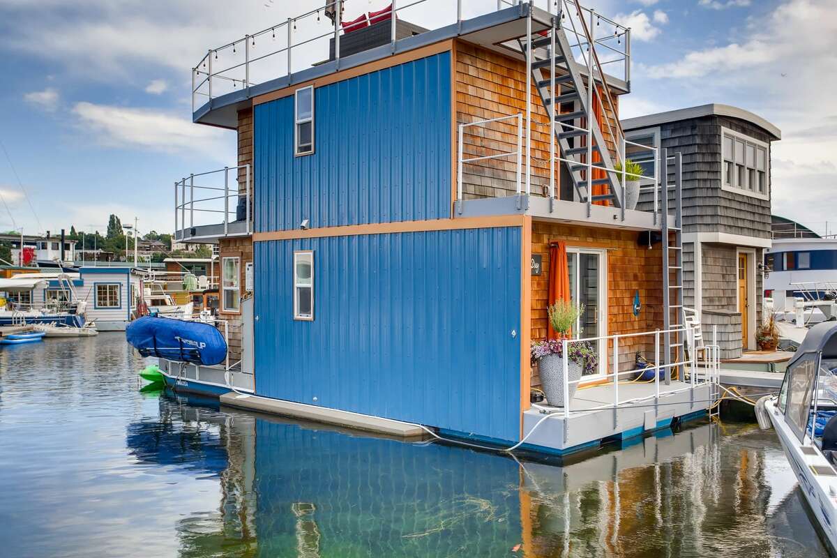 For the price of a condo, you could live in this $489K free-standing (or floating) home with a roof deck overlooking Lake Union.