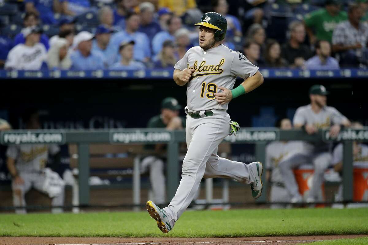 Oakland Athletics' Josh Phegley runs home to score on a triple by Marcus Semien during the second inning of a baseball game against the Kansas City Royals, Monday, Aug. 26, 2019, in Kansas City, Mo. (AP Photo/Charlie Riedel)