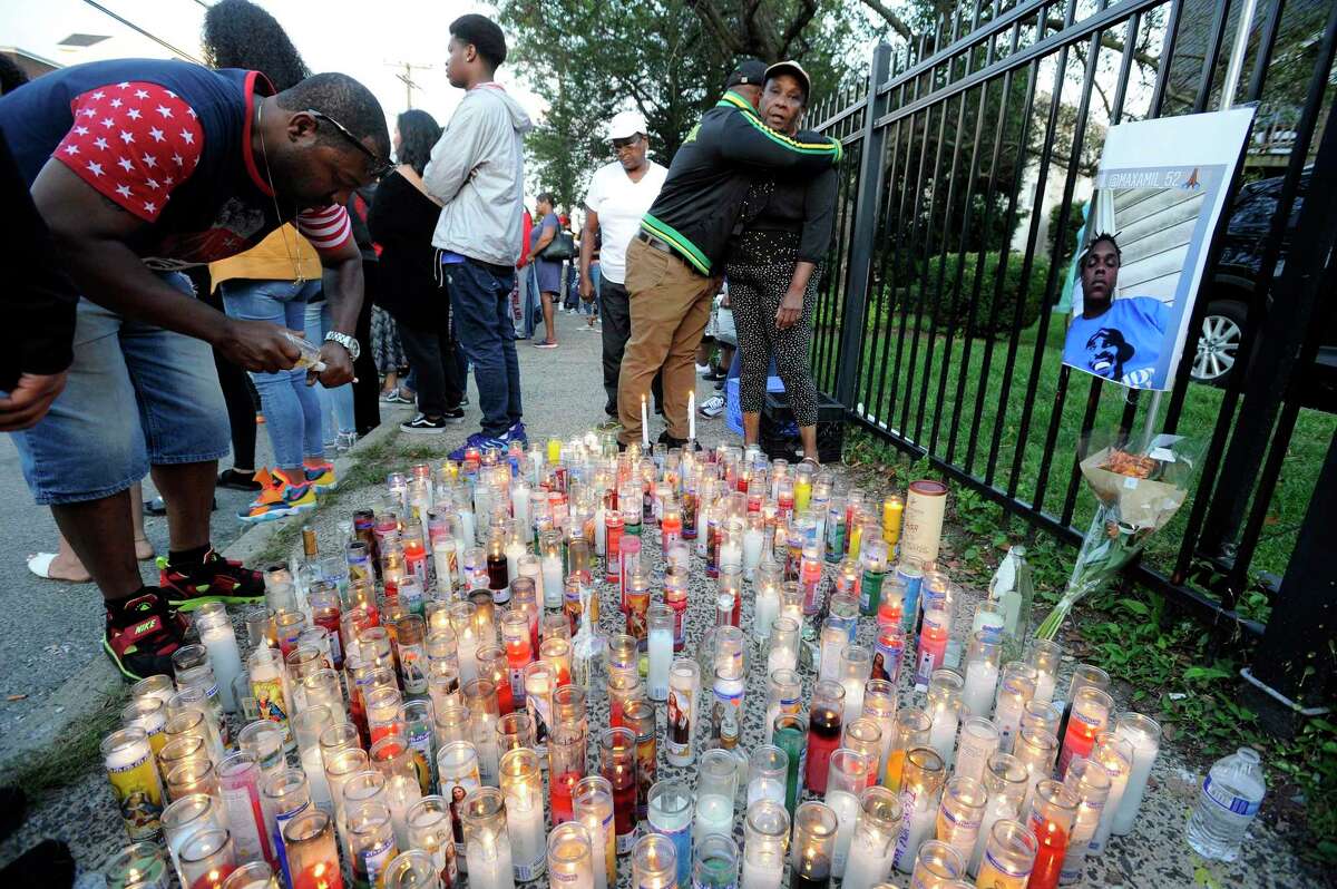 Kenneth Johnson of Hartford, at left, lights a remembrance candle for his nephew Kymoni Pollock on Tuesday August 27, 2019 where more than hundreds of friends gathered on Ludlowe Street in Stamford, Connecticut to hold a vigil and reflect on the loss of their friends. Kymoni Pollock and NiShawn Tolliver were fatally killed in a car crash early Monday morning. Four other individuals were injured in the crash at Canal and Ludlowe Street near Pollocks homothers involved in the crash.