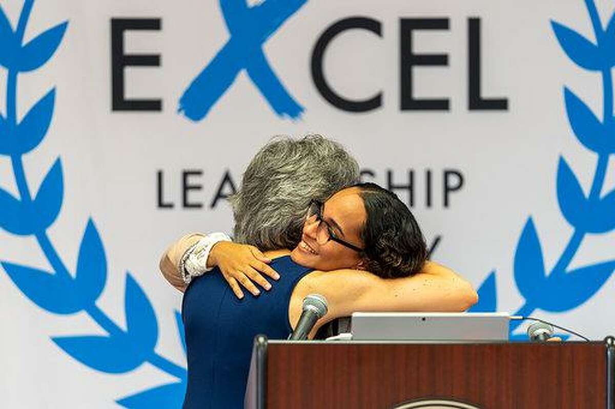 Natalia Rodriguez hugging her favorite high school teacher, Maria Zampano, on Aug. 20 during the Summer Institute sponsored by the ExcEL Leadership Academy at Shelton High School.