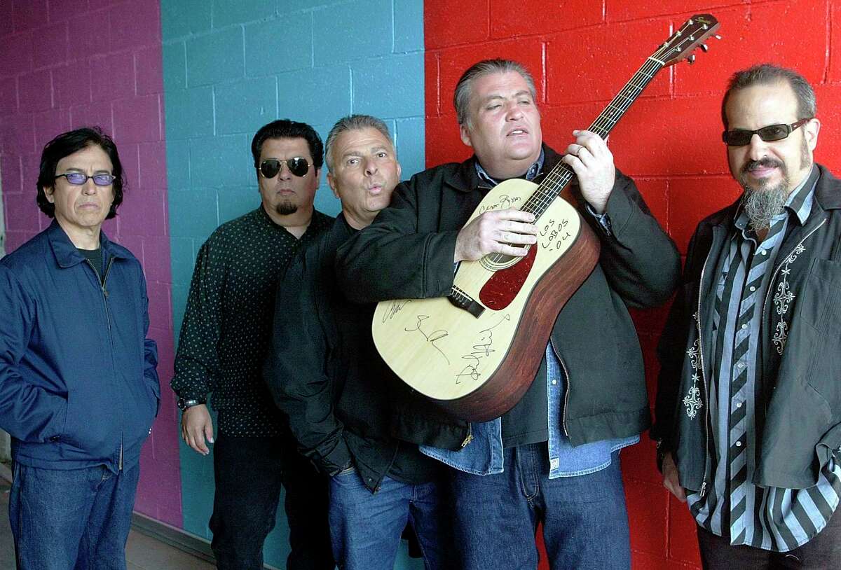 FILE - This April 7, 2004 file photo shows members of the band Los Lobos, from left, Louie Perez, Cesar Rosas, Conrad Lozano, David Hidalgo holding a guitar, and Steve Berlin posing for a photograph, in Los Angeles. They are the progenitors of Chicano rock ‘n’ roll, the first band that had the boldness, and some might say the naiveté, to fuse punk rock with Mexican folk tunes. (AP Photo/Damian Dovarganes, file)