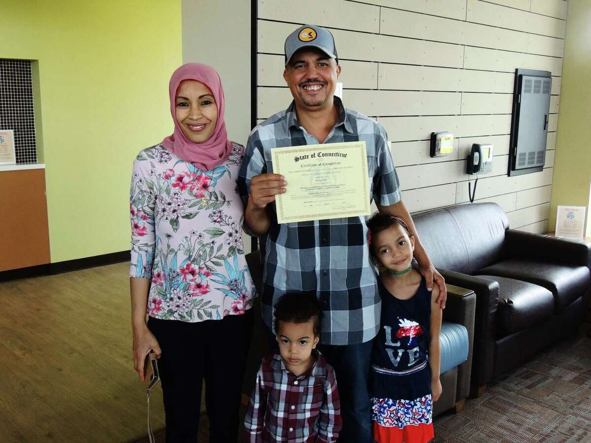 Middlesex Community College student Hassan Touil of Middletown, center, was joined by his family to celebrate completing Workforce Alliance’s Skill Up for Manufacturing program Aug. 12.