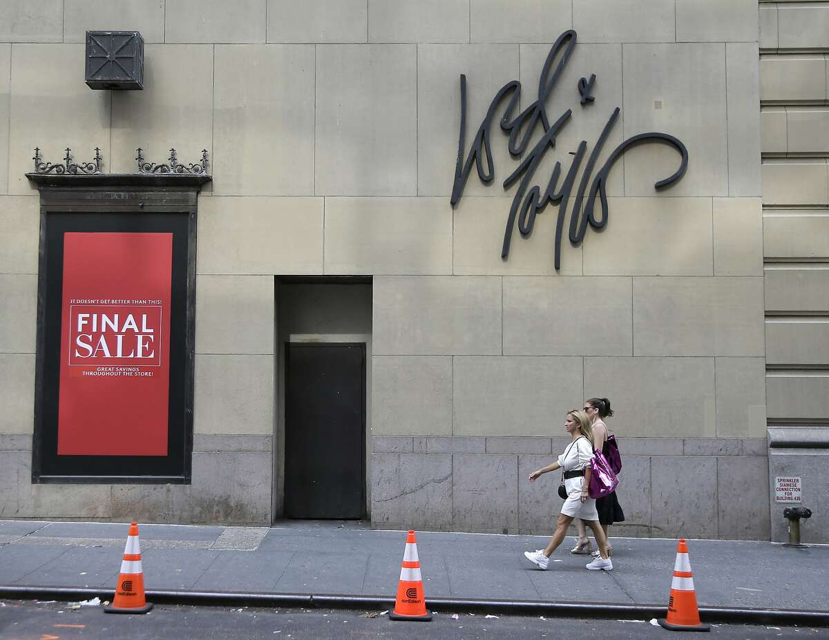 FILE - In this Oct. 4, 2018, file photo signs advertising the closing of a Lord & Taylor store are displayed in New York, Thursday. Lord & Taylor, one of the nation’s oldest department stores, is being sold for $100 million. The retailer’s owner, Hudson's Bay Co., says it reached a deal with online rental clothing company Le Tote Inc. (AP Photo/Seth Wenig, File)