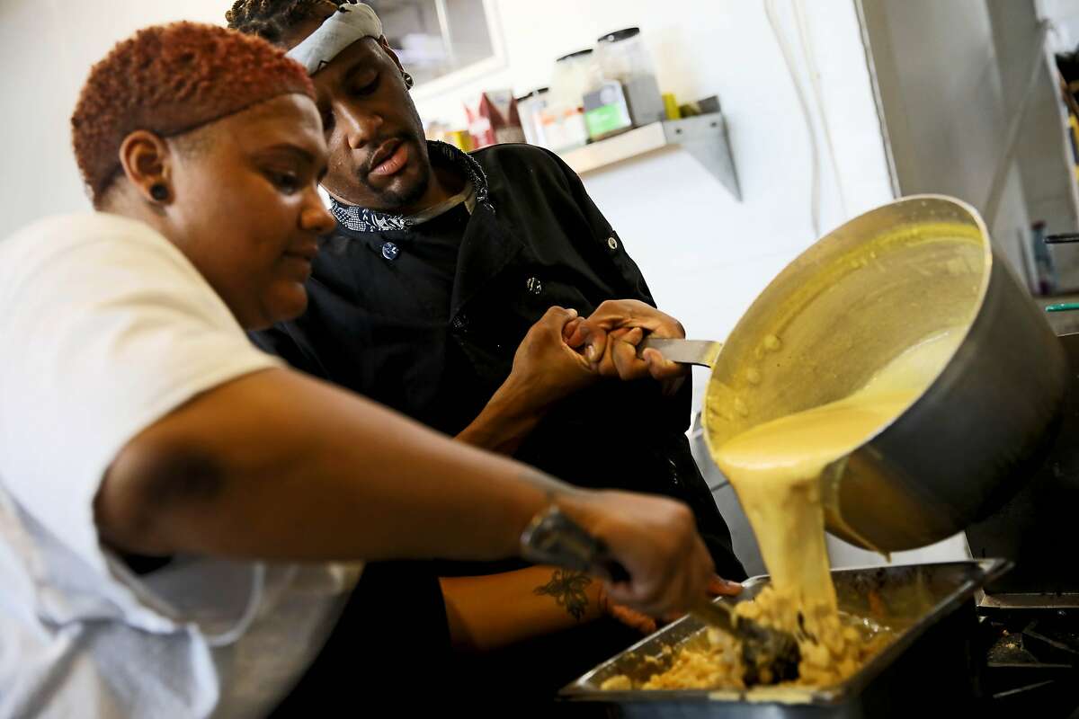 Rianna Armstead (left), 25, and her brother Rashad Armstead, 31, make macaroni and cheese at Grammie's Down-Home Chicken in Oakland, Calif., on Friday, August 2, 2019.