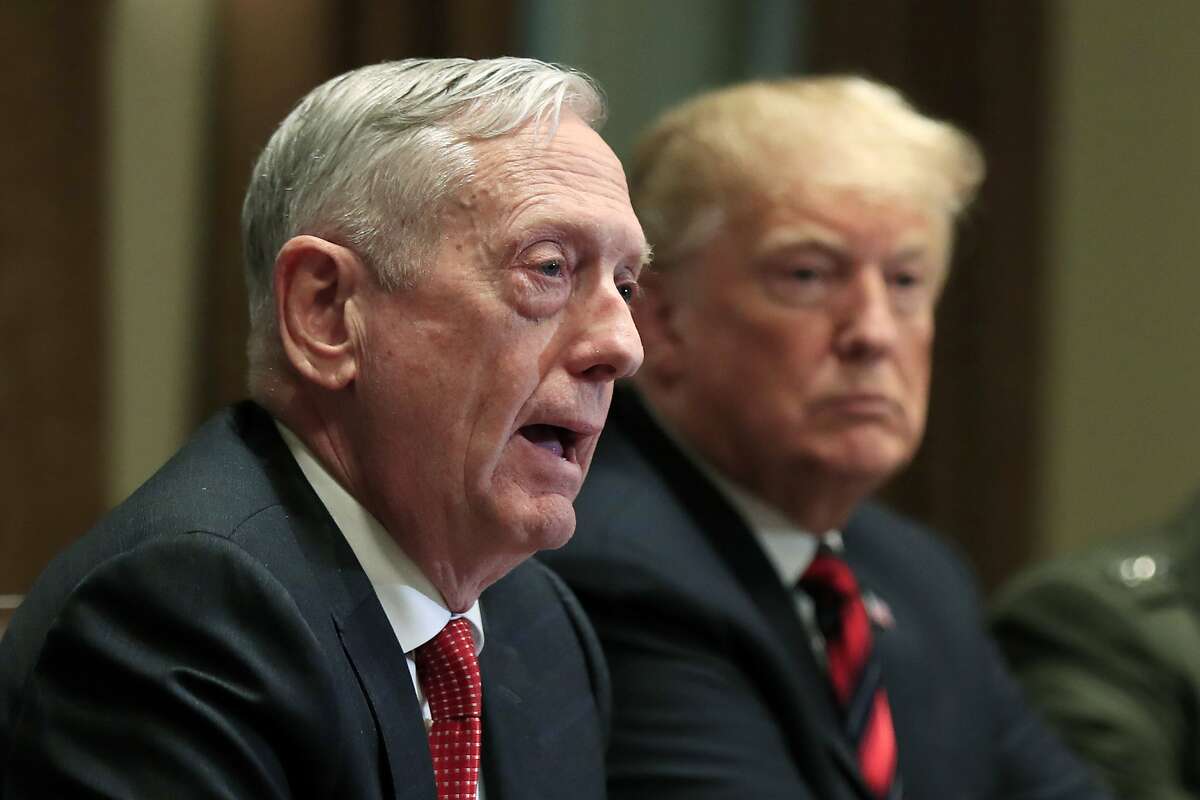 In this Oct. 23, 2018 file photo, Defense Secretary Jim Mattis speaks beside President Donald Trump, during a briefing with senior military leaders in the Cabinet Room at the White House in Washington.  Mattis excoriated Trump on Wednesday, June 3, 2020, accusing the nation's chief executive of deliberately trying to divide Americans, taking exception to his threats of military force on American streets, and praising those demanding justice following the police killing of George Floyd.