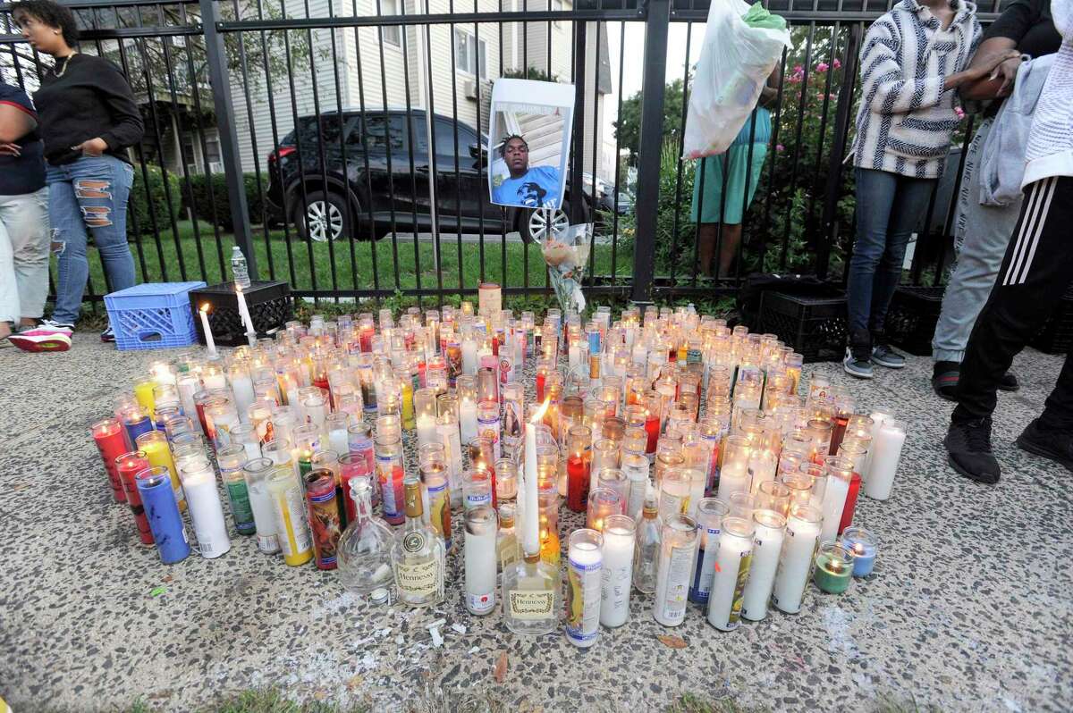 Candles are placed in front of a picture of Ky-Mani Antoine-Pollack during a vigil held in his remembrance on Ludlow Street in Stamford, Connecticut on August 27, 2019.