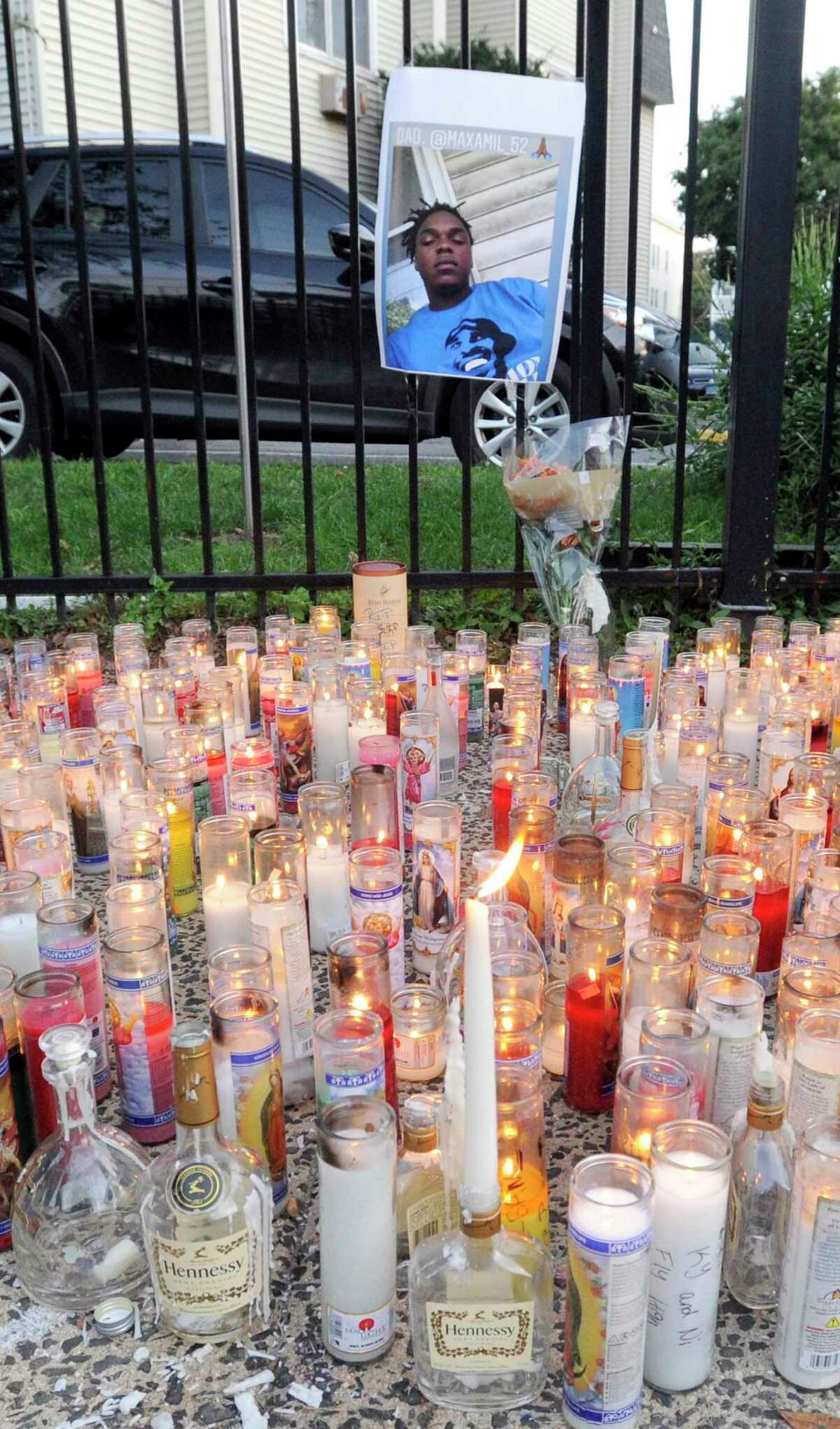 Candles are placed in front of a picture of Ky-Mani Antoine-Pollack during a vigil held in his remembrance on Ludlow Street in Stamford, Connecticut on August 27, 2019.