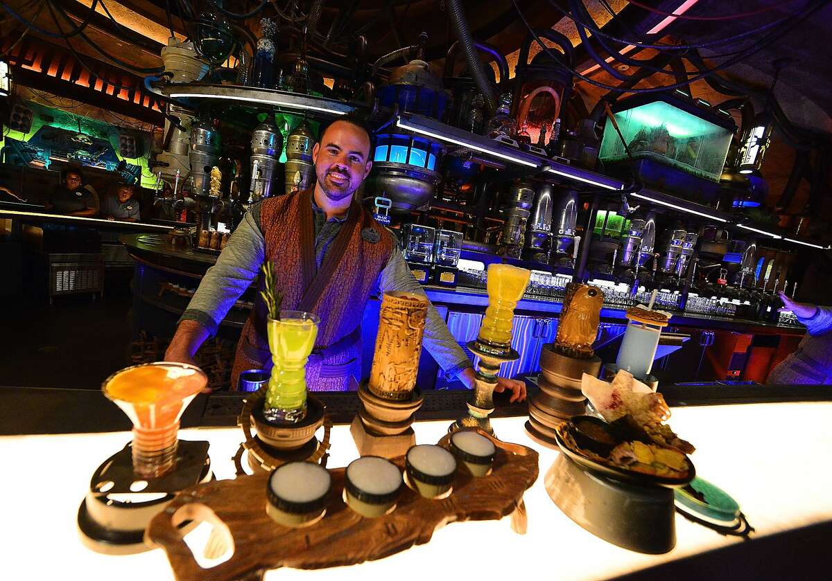 FILE - A cast member poses at the Oga's Cantina at the Black Spire Outpost at the Star Wars: Galaxy's Edge Walt Disney World Resort Opening at Disney's Hollywood Studios on August 27, 2019 in Orlando, Florida. Would you pay extra money to bypass the line for rides?