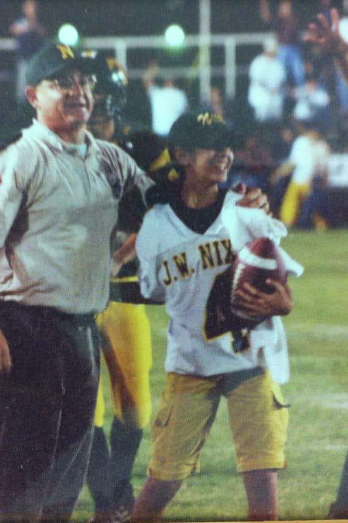 Alex and Robyn Colin are pictured on the sidelines during a 2001 Nixon football game.