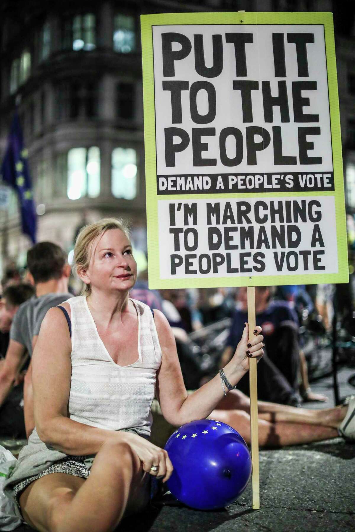 Anti-Brexit supporters continue to participate in a late evening protest in front of the Houses of Parliament in central London, Wednesday, Aug. 28, 2019. British Prime Minister Boris Johnson maneuvered on Wednesday to give his political opponents even less time to block a no-deal Brexit before the Oct. 31 withdrawal deadline, winning Queen Elizabeth II's approval to suspend Parliament. (AP Photo/Vudi Xhymshiti)