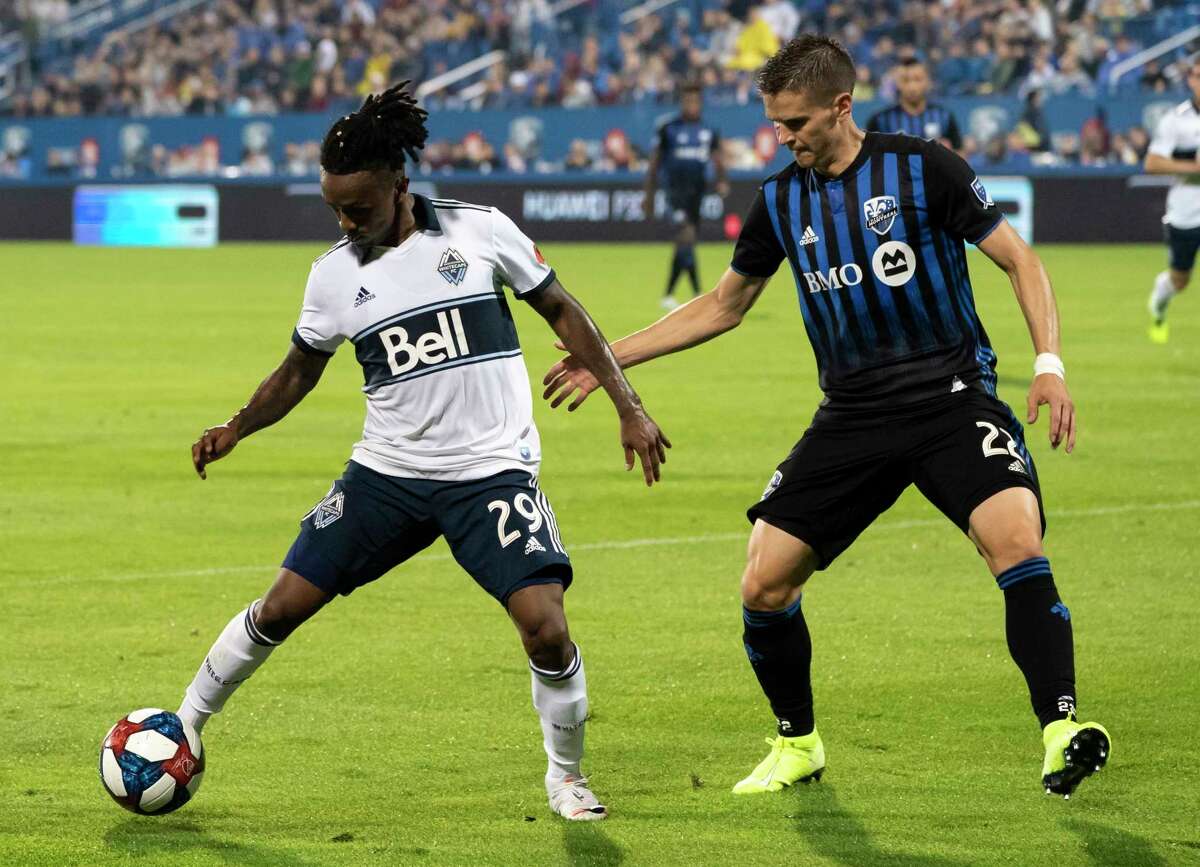 Vancouver Whitecaps forward Yordi Reyna controls the ball away from Montreal Impact defender Jukka Raitala during the first half of an MLS soccer match Wednesday, Aug. 28, 2019, in Montreal. (Paul Chiasson/The Canadian Press via AP)