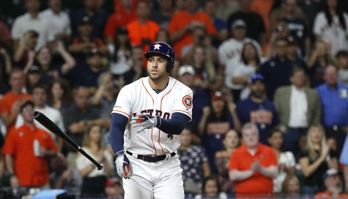 Houston Astros George Springer (4) tosses his bat aside as he was walked with bases loaded, scoring a run during the eighth inning of an MLB baseball game at Minute Maid Park, Wednesday, August 28, 2019.