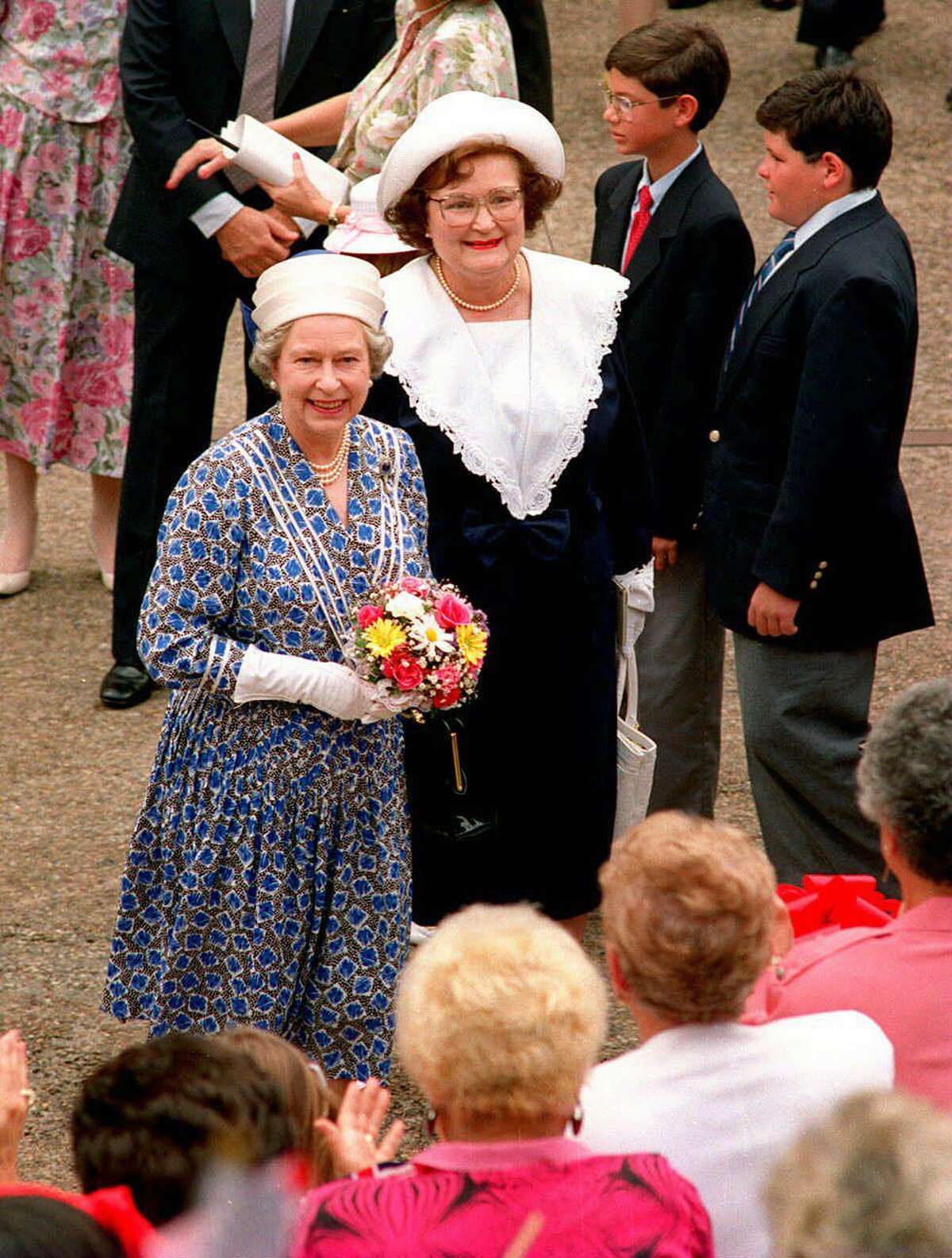 Queen Elizabeth II, foreground, and Mayor Lila Cockrell greet the crowd during the queen’s visit to San Antonio in May 1991.
