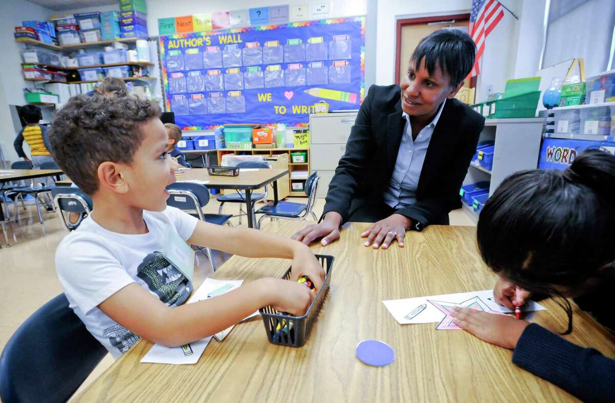 Superintendent Tamu Lucero chats with Kenny, a kindergartener in Miss Melissa Sempey's class at KT Murphy School, during a visit on the first day of school on August 29, 2019 in Stamford, Connecticut.