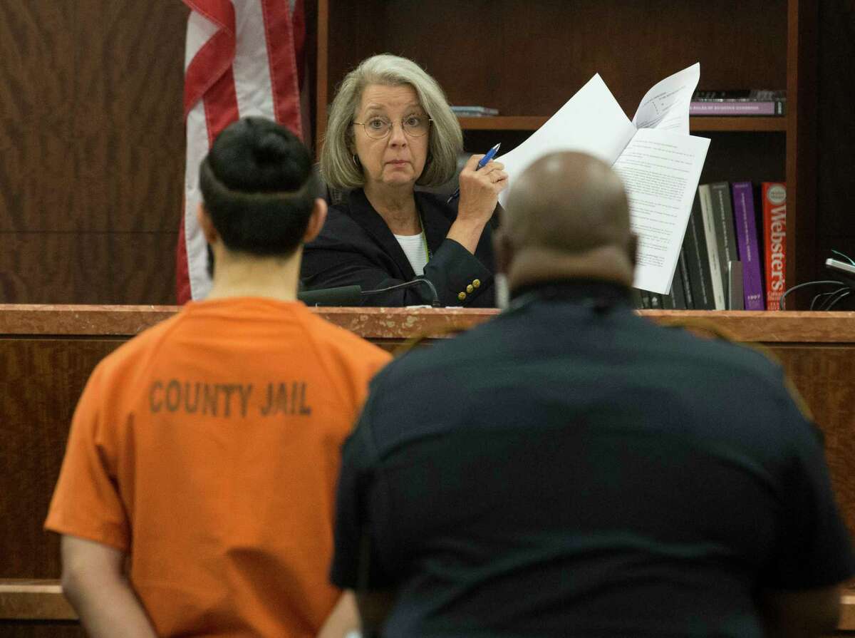 Judge Jeannine Barr reads the document to Nasim Irsan, who is pleading guilty to a murder charge for firing the shot that killed Gelareh Bagherzadeh, 30, on Thursday, Aug. 29, 2019, in Houston. Irsan shot Bagherzadeh at the urging of his father and mother. He was sentenced 40 years in prison and will be eligible for parole after serving 20 years. Irsan's father, Ali Irsan, was sentenced to death for two grisly “honor killings” of Bagherzadeh and his son-in-law.
