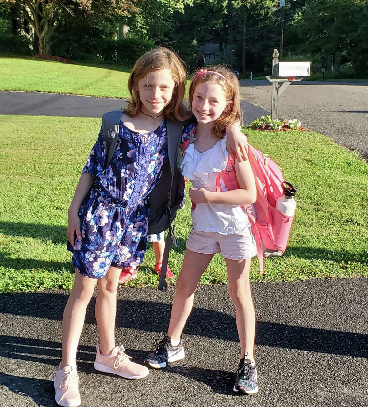 Claire Targowski Anna Broas wait for the bus to Tashua Elementary.