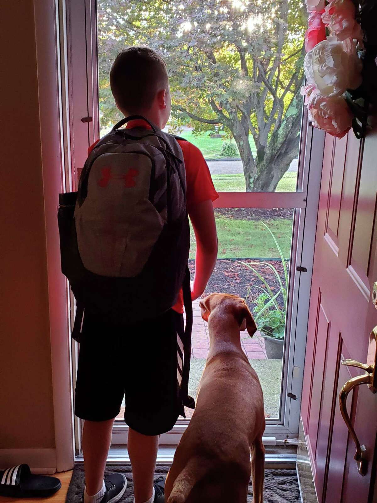 Scotty Targowski and his buddy Emmy wait for the bus to Madison Middle School.