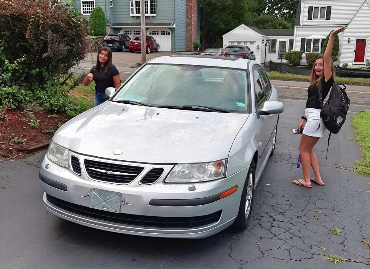 Trumbull High senior Jaclyn Irizarry does a dance of joy as she prepares to drive herself and sister, Samantha, 10th grade, to school in her own car.