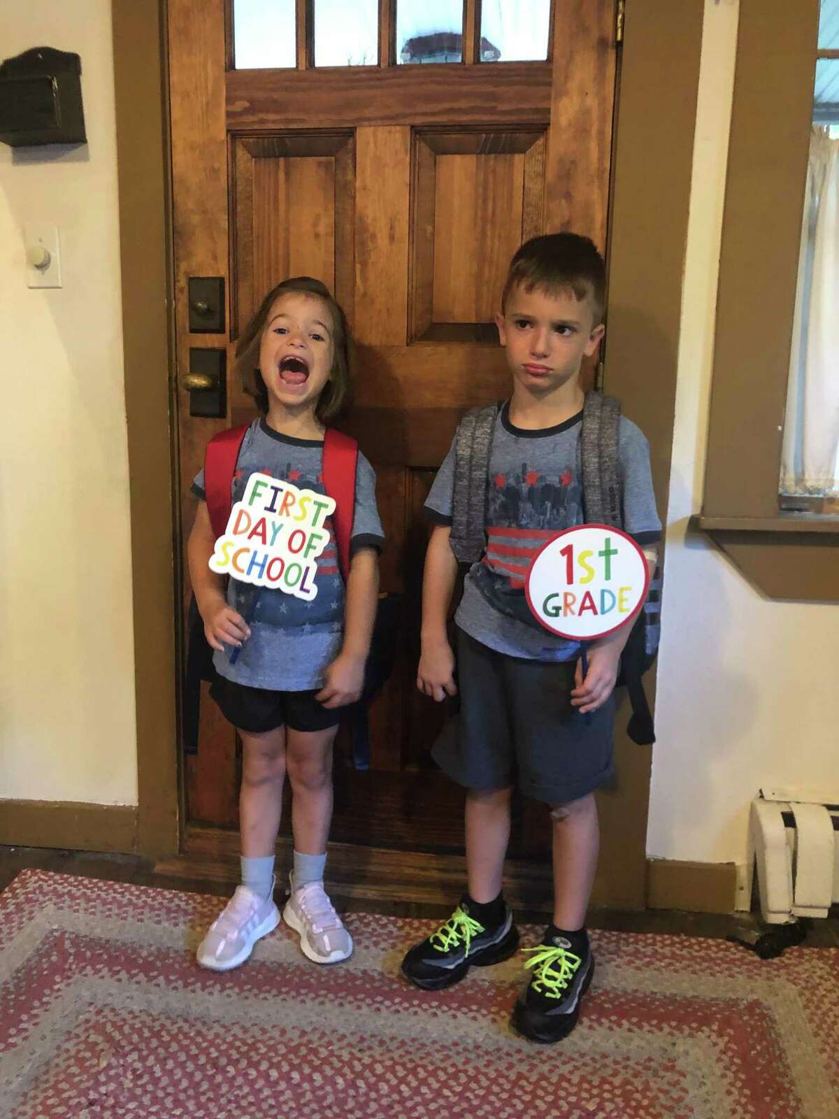 Incoming Tashua first graders, twin siblings Stella (left) and Caleb Petrossi have very different emotional reactions to the first day of school
