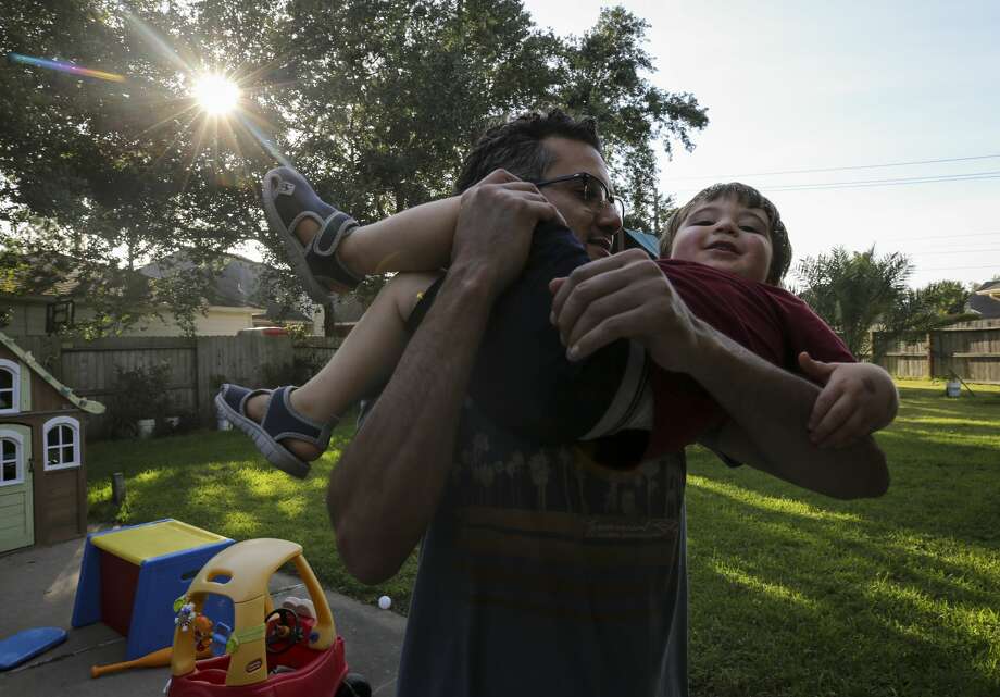 Shoja Zaidan plays with his nephew, Elias, in the backyard of his parents' home. "I think everything made us stronger because it made us realize no matter what, we're still together," said Shoja. "We're still family." Photo: Godofredo A. Vásquez/Staff Photographer