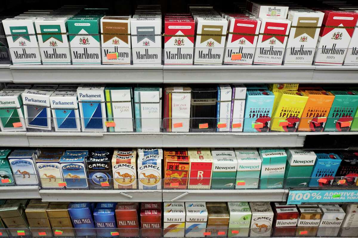 FILE - This Aug. 28, 2017 file photo shows cigarettes displayed on a store shelf in New York. (AP Photo/Mark Lennihan, File)