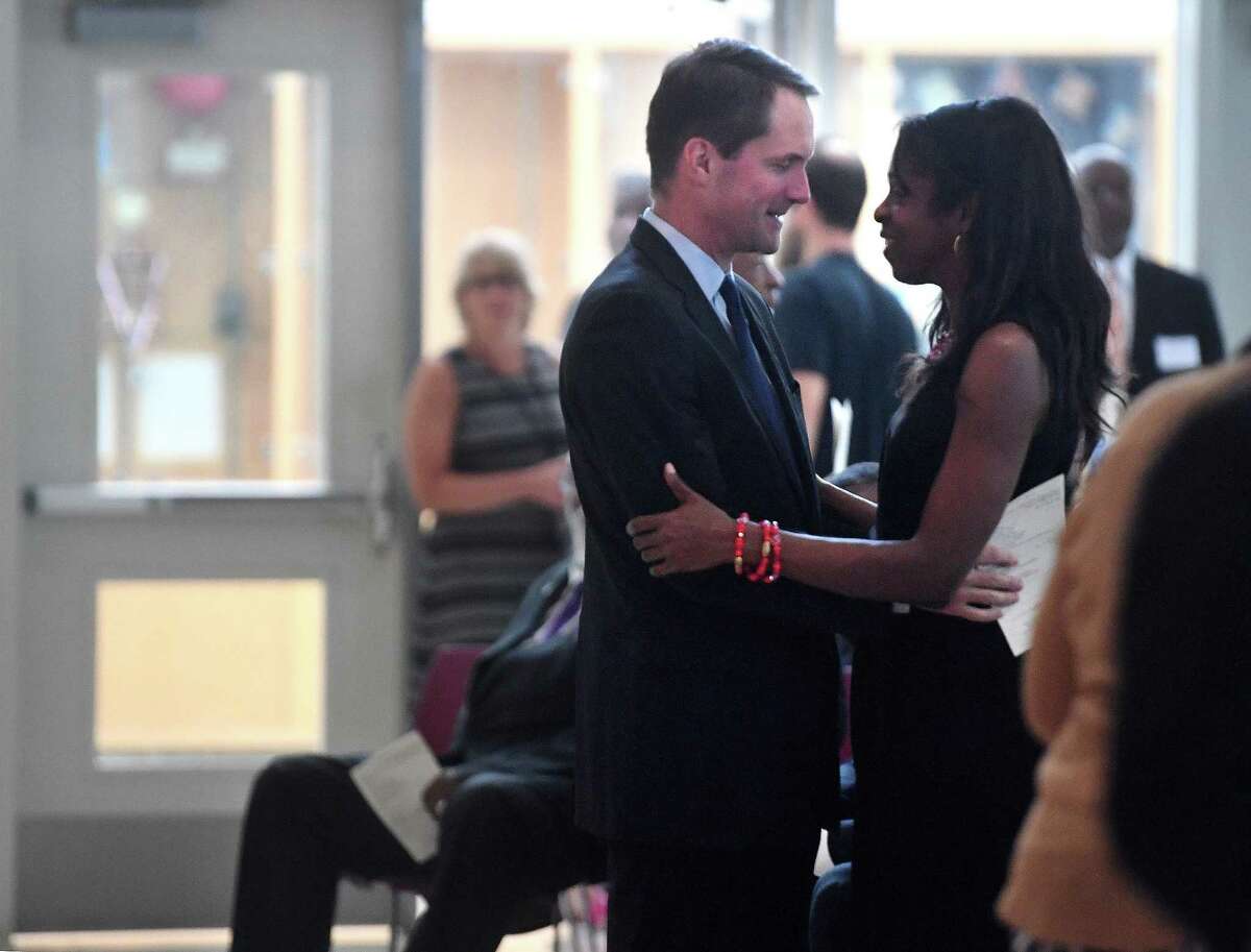 Rep. Jim Himes greets Stacey Tisdale, daughter of Charles Tisdale, at the memorial service in honor of her father at Jettie Tisdale Elementary School in Bridgeport, Conn. on Thursday, August 29, 2019.