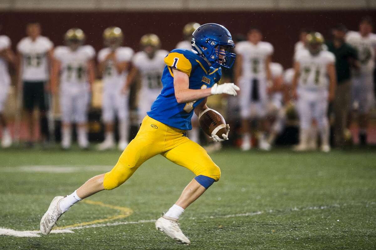 Midland's Bryce Albrecht carries the ball down the field during the Chemics' game against Traverse City West Thursday, Aug. 29, 2019 at Midland Community Stadium. (Katy Kildee/kkildee@mdn.net)