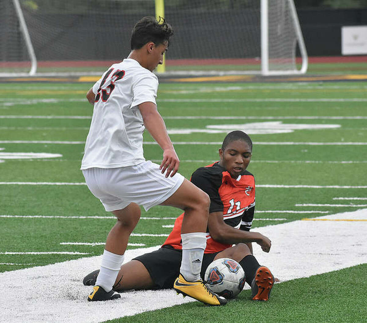 Edwardsville midfielder Tony Agwuedu attempts a diving tackle in the first half.