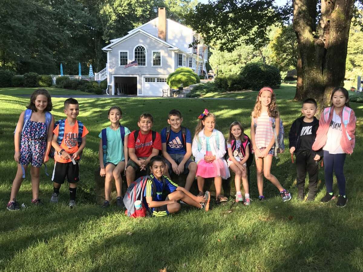 The neighborhood waits for the bus at the Firehouse Road and Parkwood Road stop.