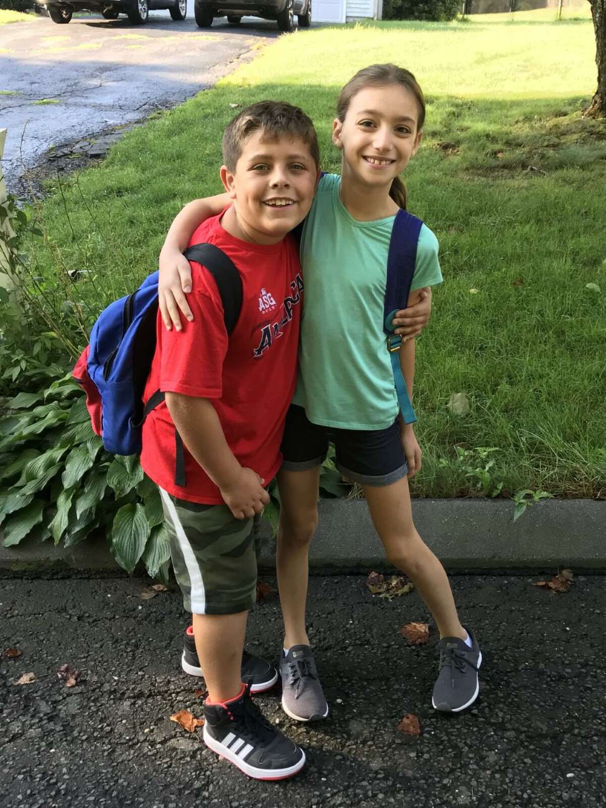 Michael Skoczylas and Carly Mofenson wait for the bus to bring them to Daniels Farm School.