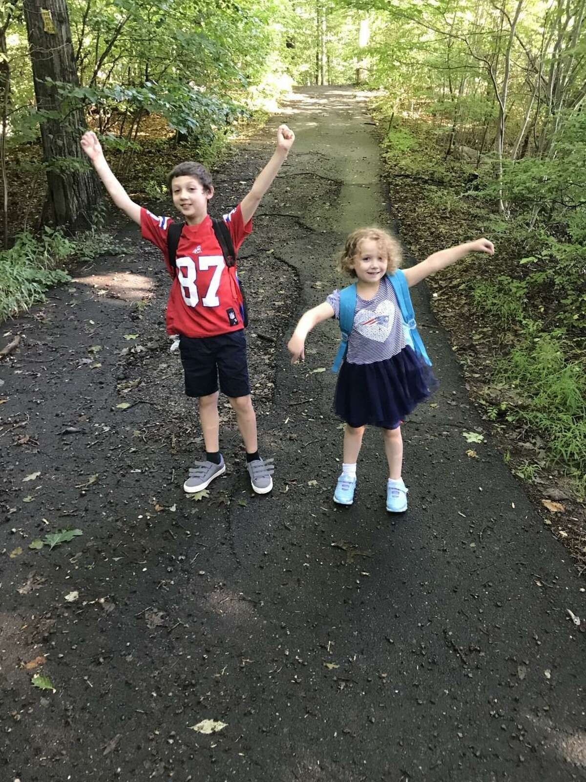 Jimmy Balestriere and Amy Balestriere walking up the path behind their house to their first day of 3rd grade and kindergarten at Middlebrook School.