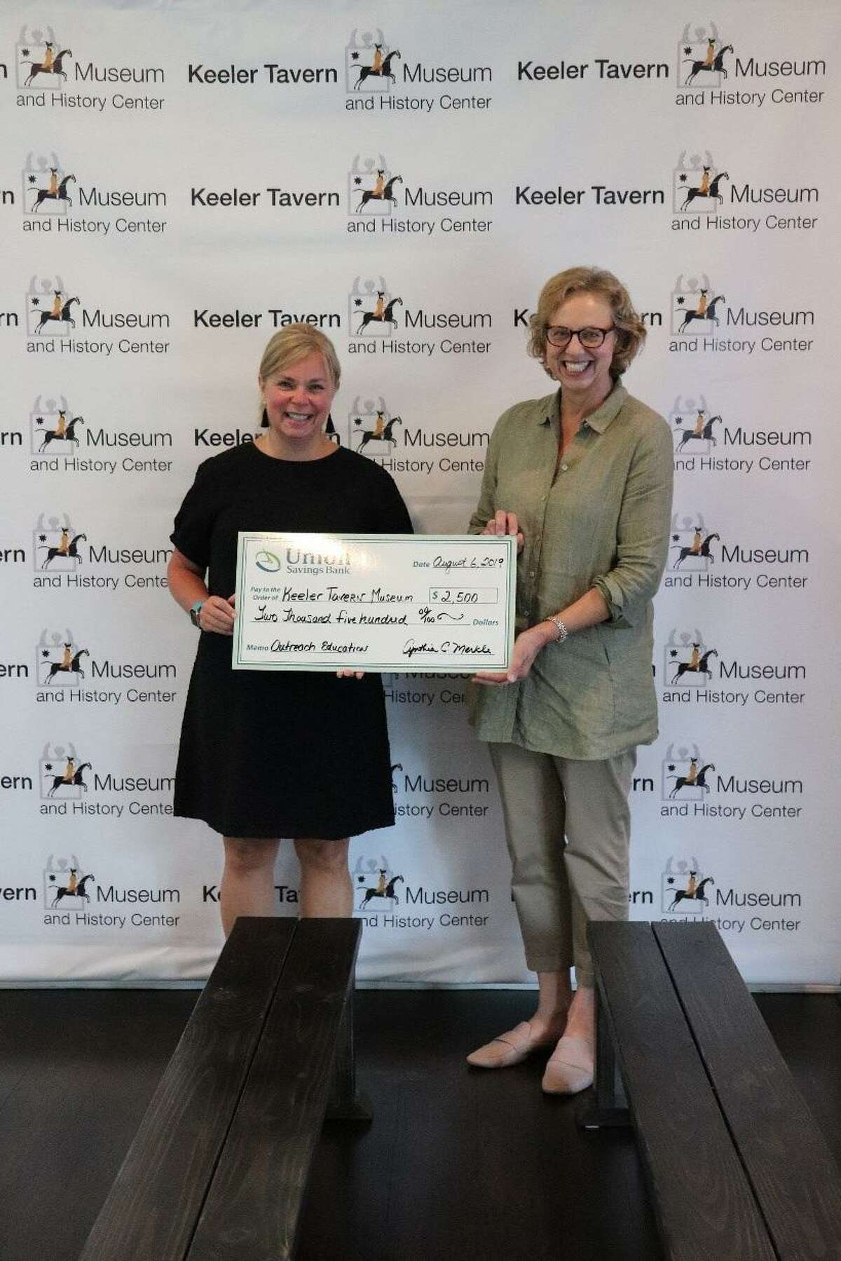 Michele Bonvicini, director of community relations at Union Savings Bank, presents a $2,500 check to Hildegard Grob, executive director at Keeler Tavern Museum & History Center. The funds will be directed toward subsidizing Title 1 school students’ attendance at KTM&HC’s full-day, immersive programs in American history.