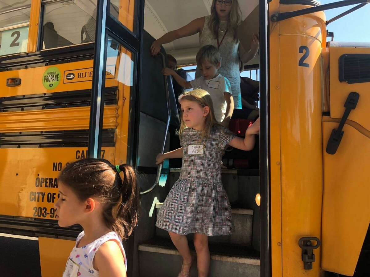 Incoming kindergartners get off the bus after going for a trial run on the morning of Friday, Aug. 30, at Elizabeth Shelton School.