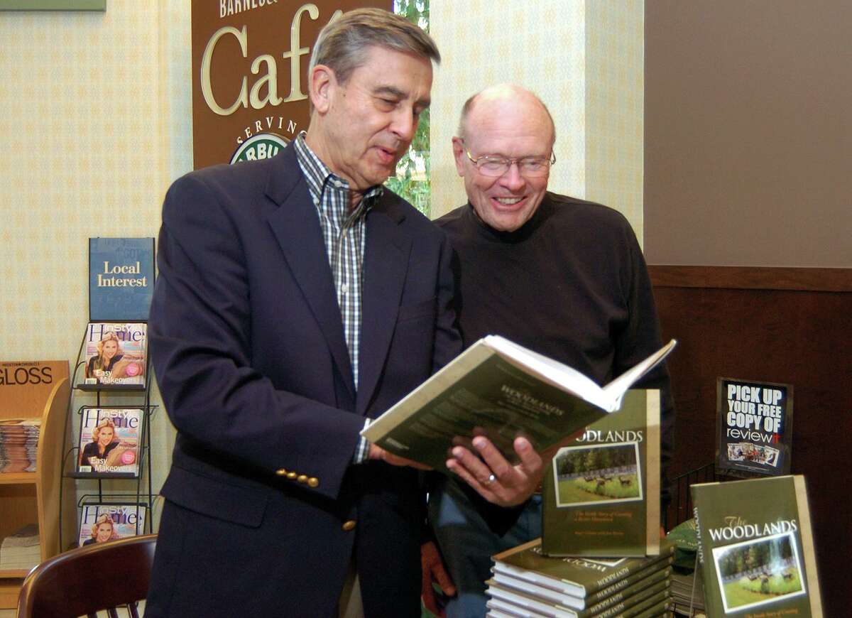 Roger Galatas and Al Kintigh, The Woodlands, look for a passage in Galatas's new book. Galatas, author of “The Inside Story of Creating a Better Hometown,” died Thursday, Aug. 29, at 83 years of age.