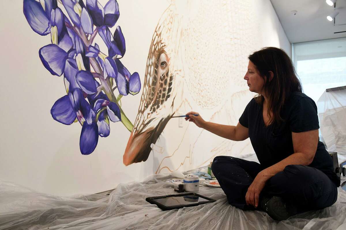 Anat Ronen, a highly regarded street artist, works on her two site-specific murals at the Pearl Fincher Museum of Fine Arts in preparation for an exhibition that opened Aug. 28, 2019.