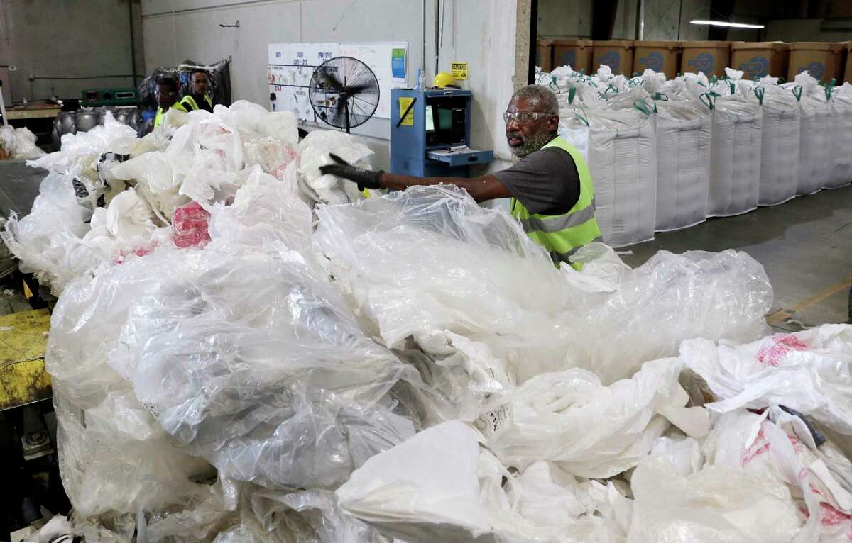 Employee Curtis Pickens sorts through used plastic film on a conveyor at the Avangard Innovative recycling facility and company headquarters Wednesday, Aug. 28, 2019 in Houston, TX.