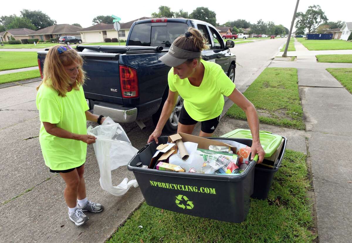 Owners of NPB recycling, Stacey Wheeler, right, and Nickey Aycock pick up recyclable material in Port Neches on Wednesday. The two women collect the material and bring it to facilities in Port Arthur and Houston to be recycled. Aycock said they collect all plastics, paper, any metal, aluminum, batteries, glass and cardboard. Photo taken Wednesday, 8/28/19